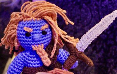 A crochet doll of Rob Anybody Feegle, carrying a large sword